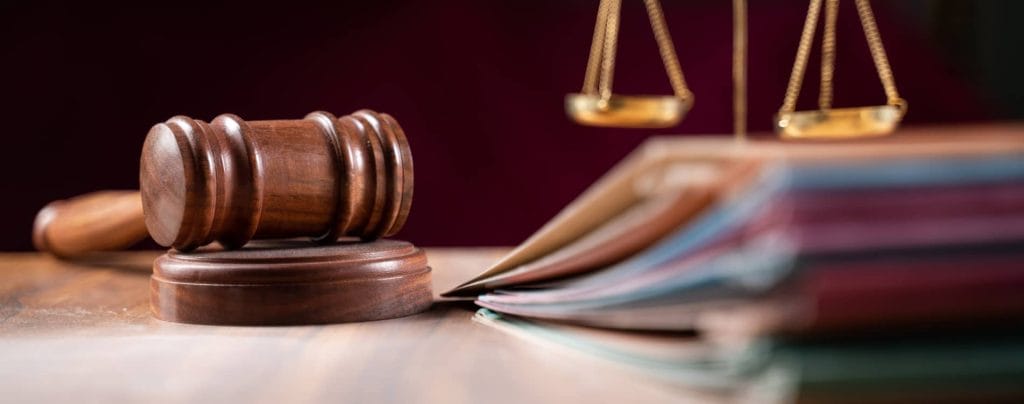 Shot of a gravel, scales and documents in a court.