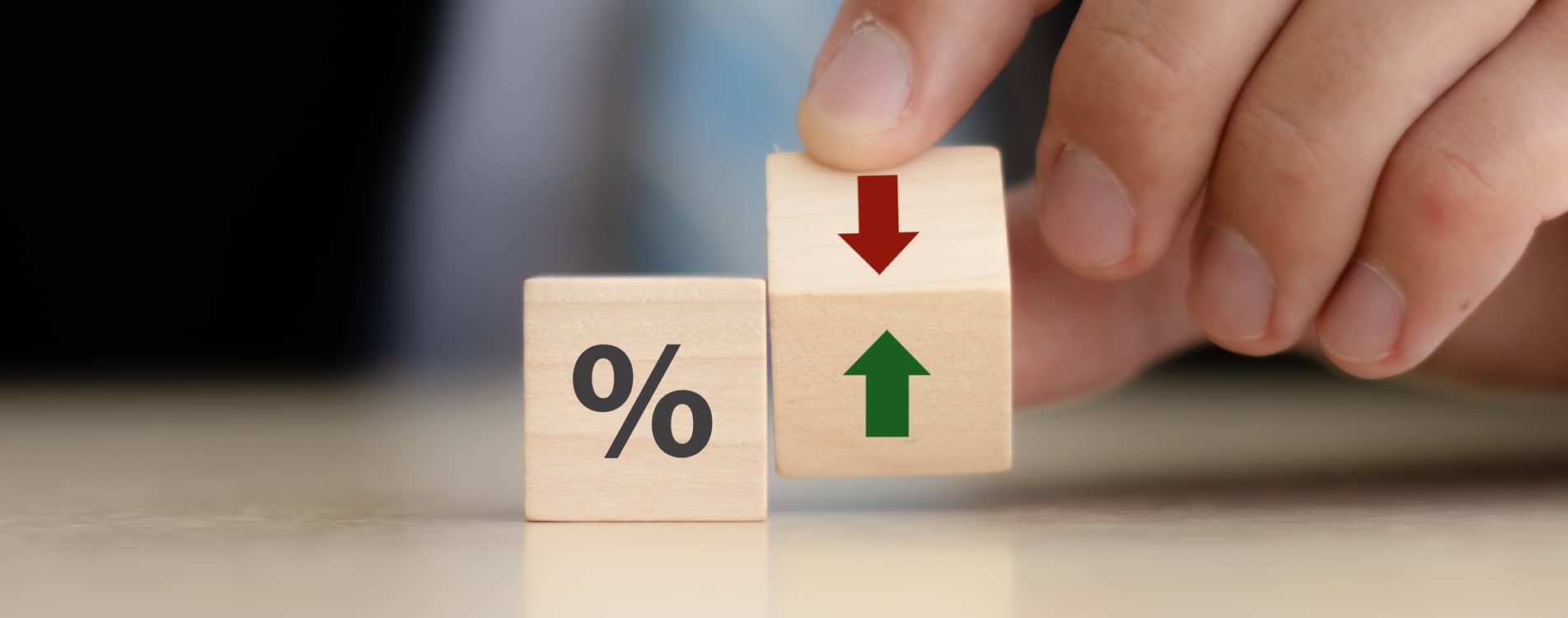 Person with two wooden dices symbolising profit loss.