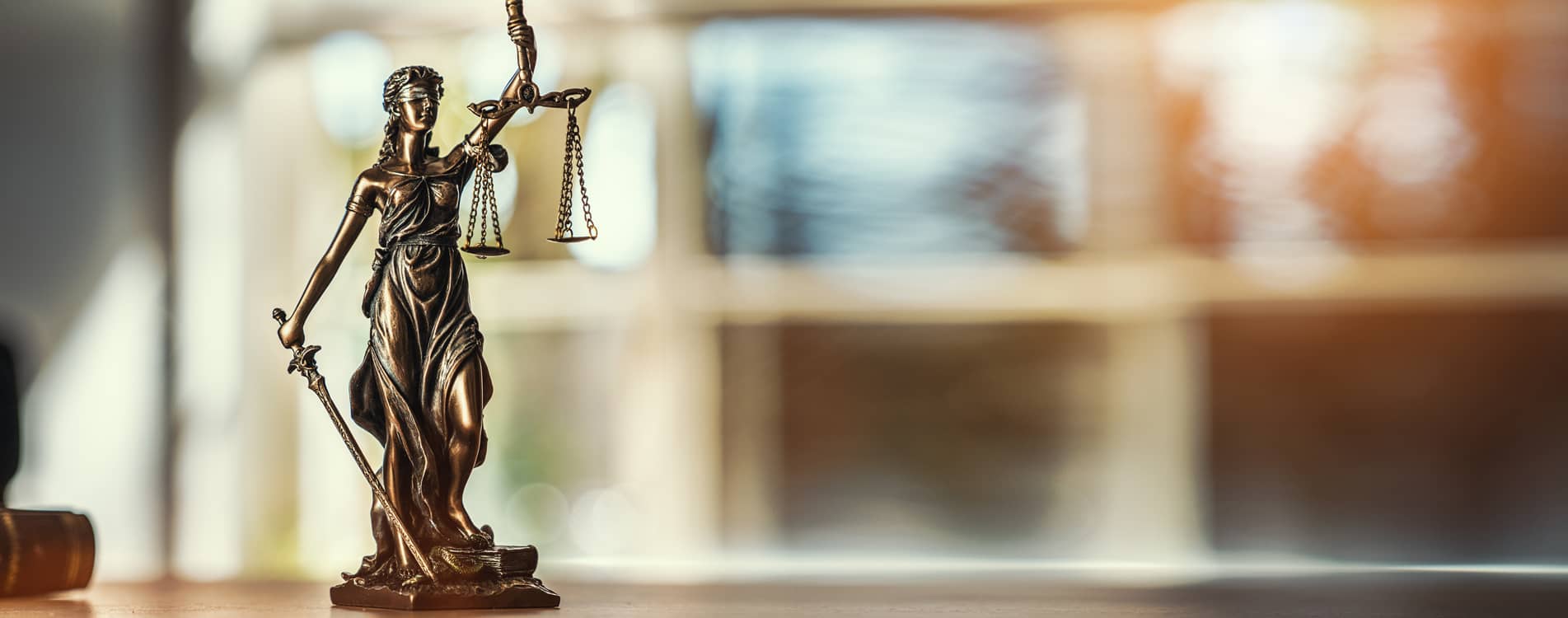 Bronze legal statue sitting on a desk.