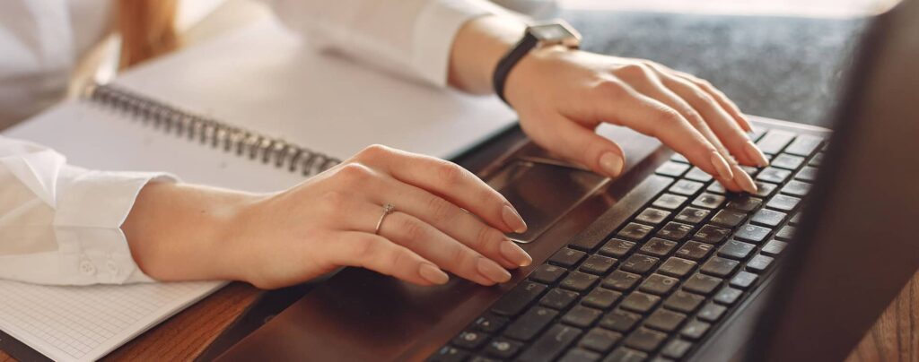 Person typing on a laptop.