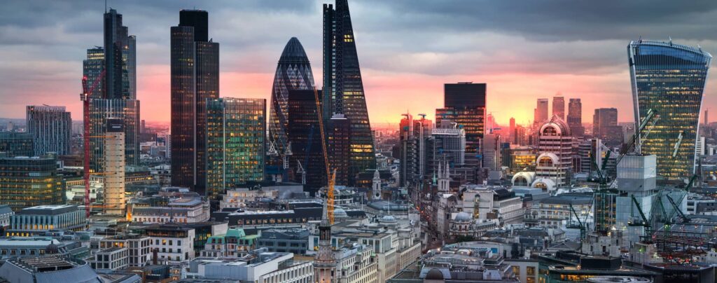 A panoramic shot of the London skyline during sunset.